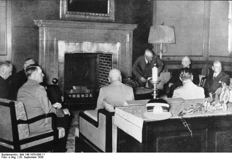 Chamberlain (covered by Hitler), Hitler, Mussolini, and Daladier negotiating at the Munich Conference
